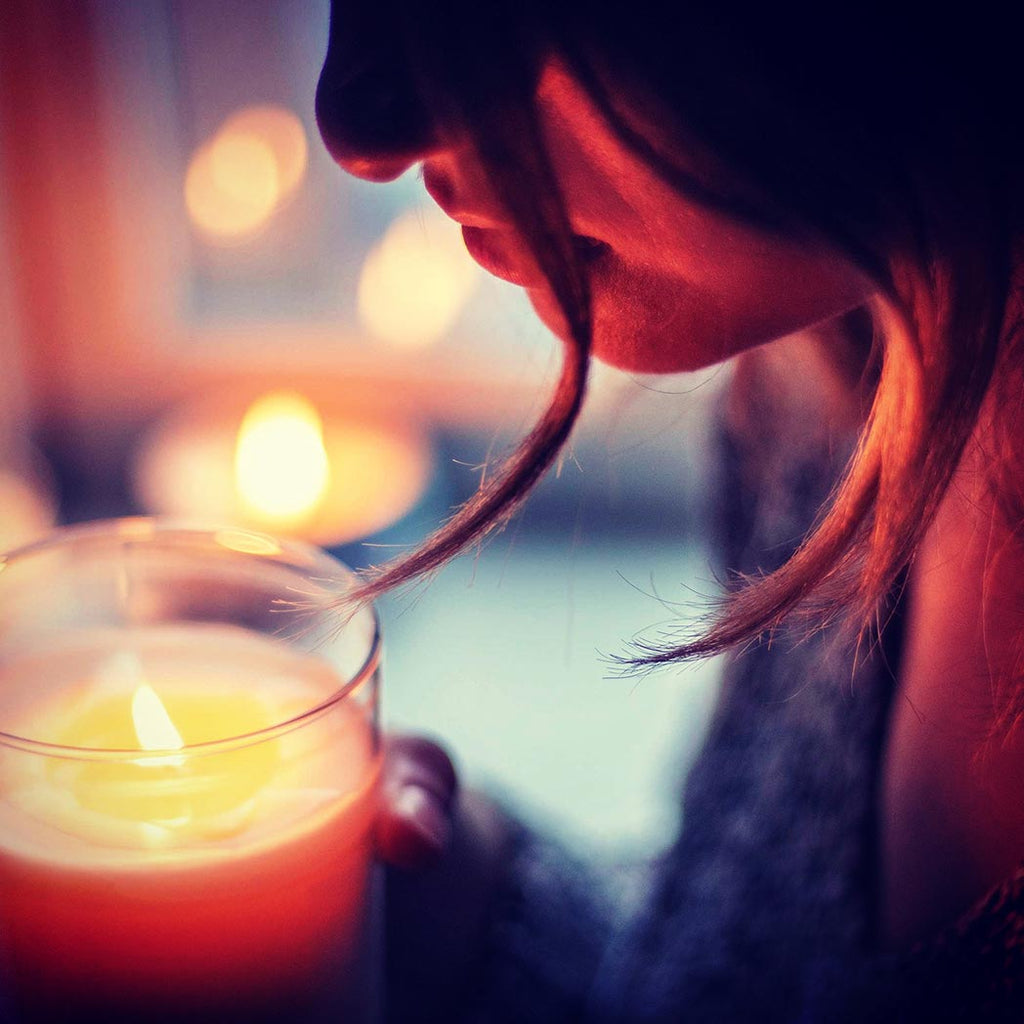 Woman smelling a scented candle